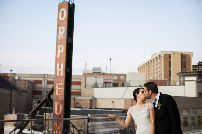 bride an groom kissing on balcony