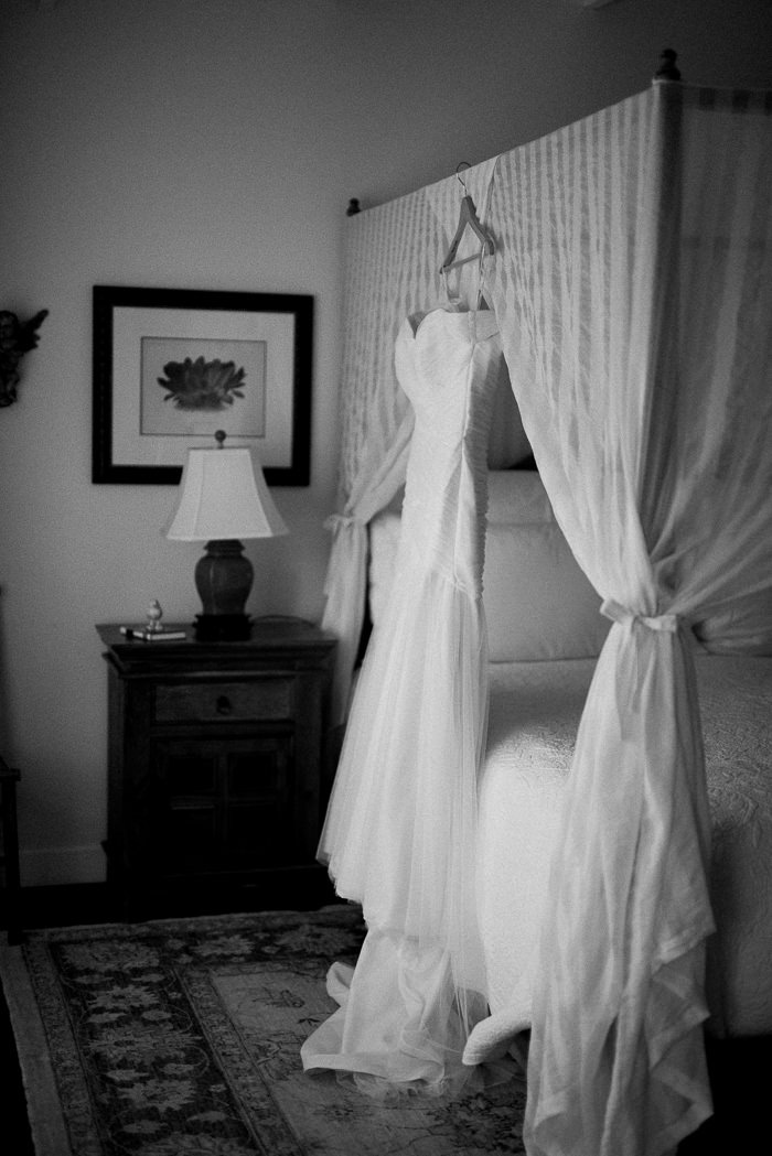 wedding dress hang in up on canopy bed