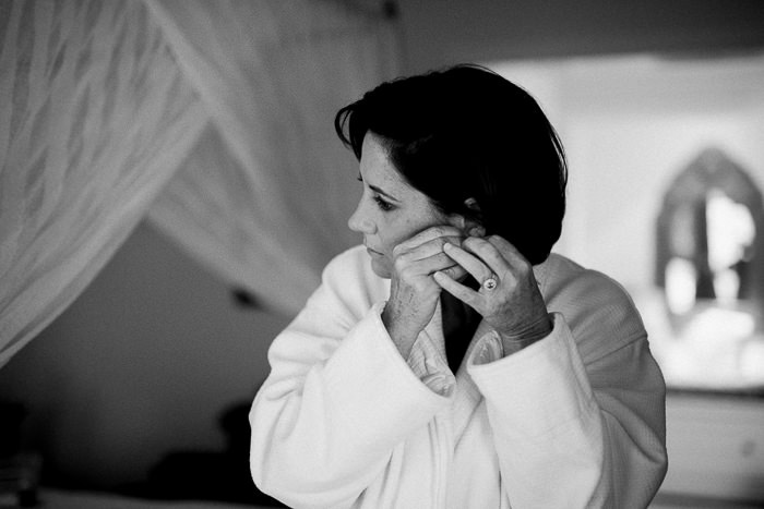 bride putting on her earrings