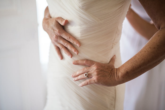 bride getting her dress buttoned