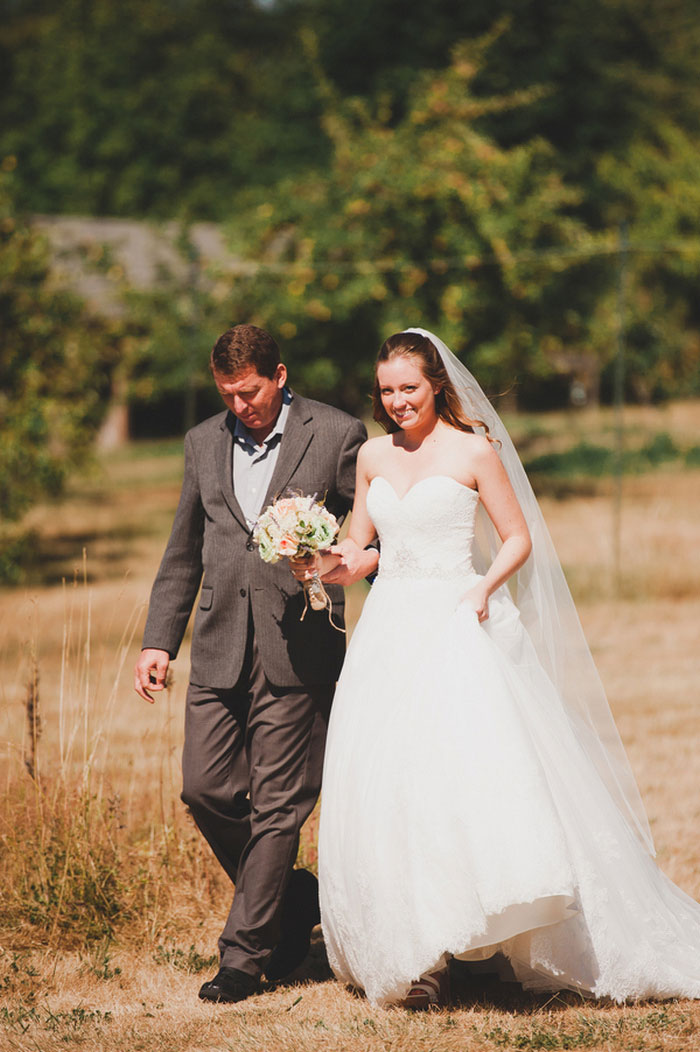 bride walking down aisle with her dad