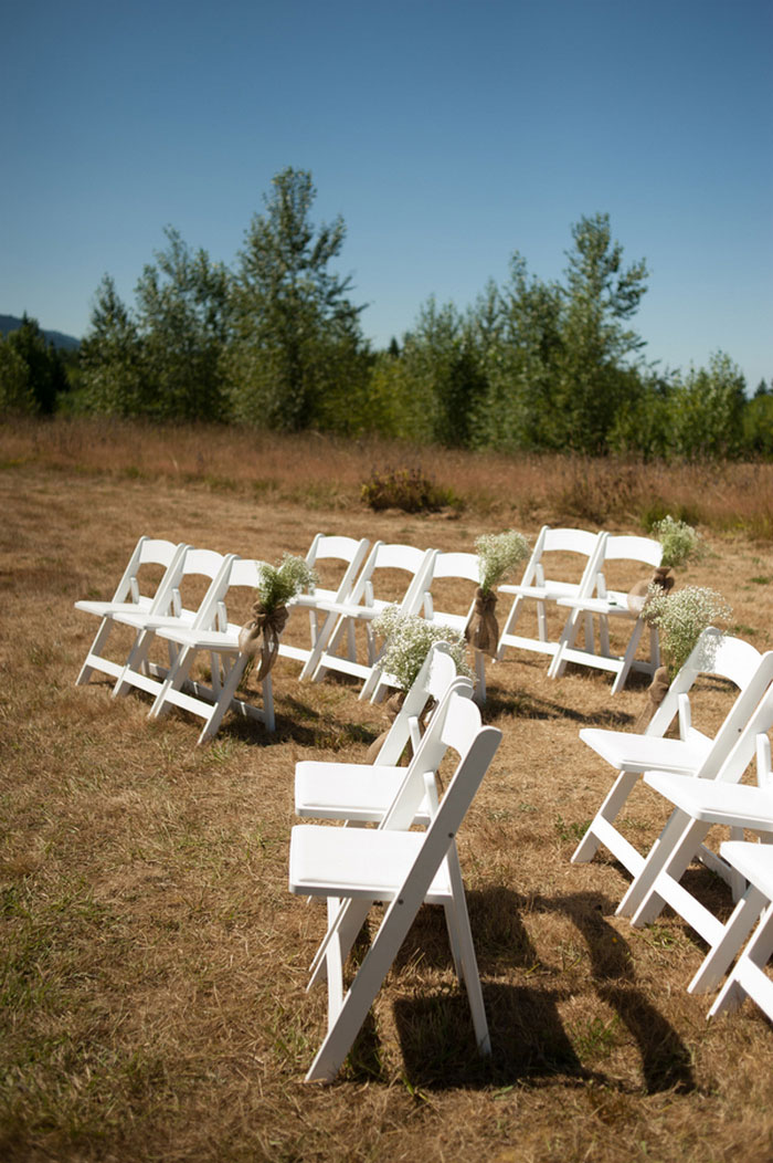 white chairs set up outdoors for ceremony