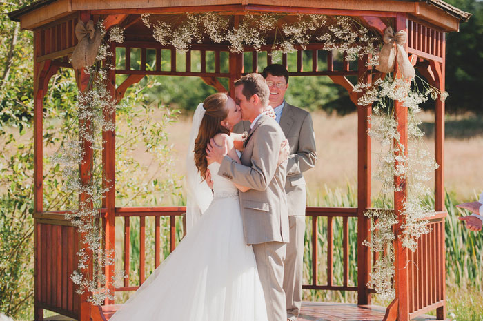 bride and groom first kiss