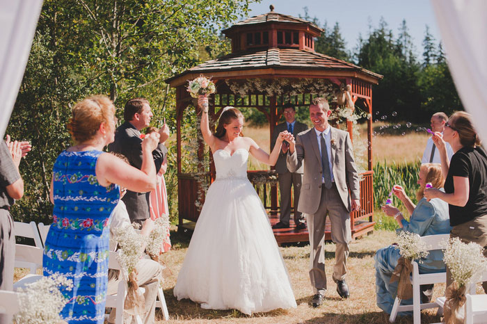 bride and groom walking up aisle