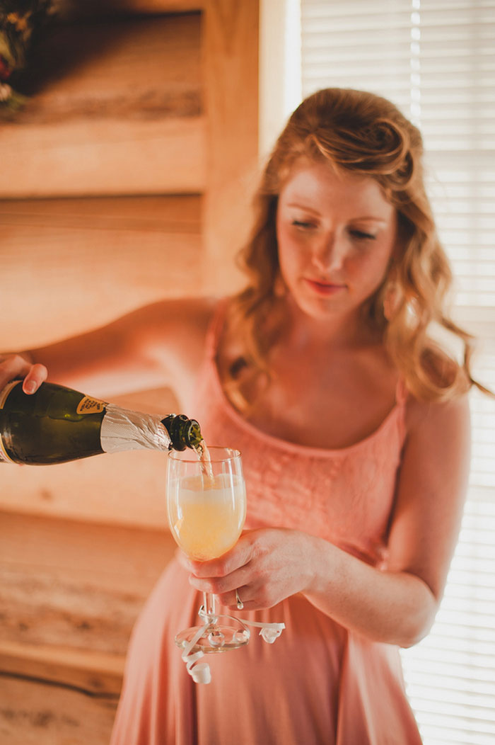 bridesmaid pouring champagne