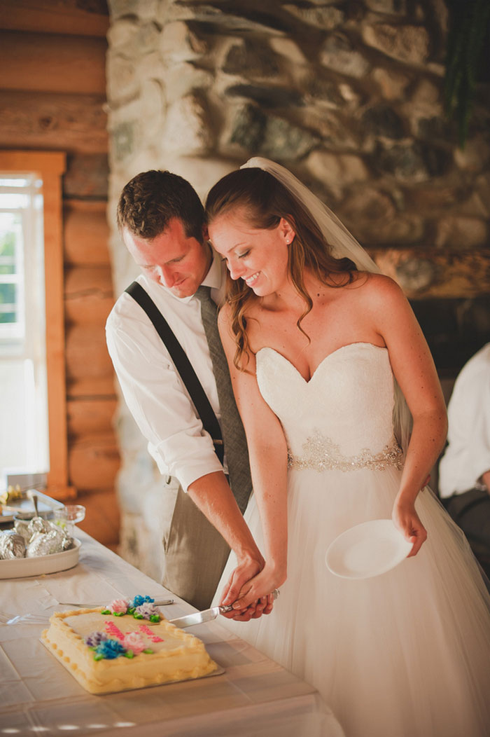 bride and groom cutting wedding cake