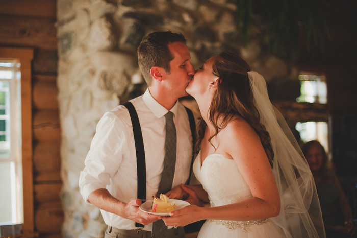 bride and groom kissing after cake cutting