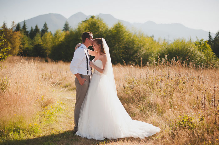 bride and groom portrait in a field
