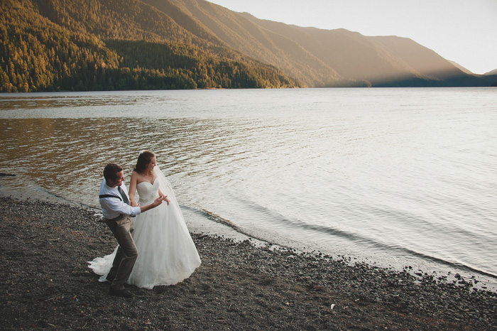 bride and groom skipping rocks on the lake