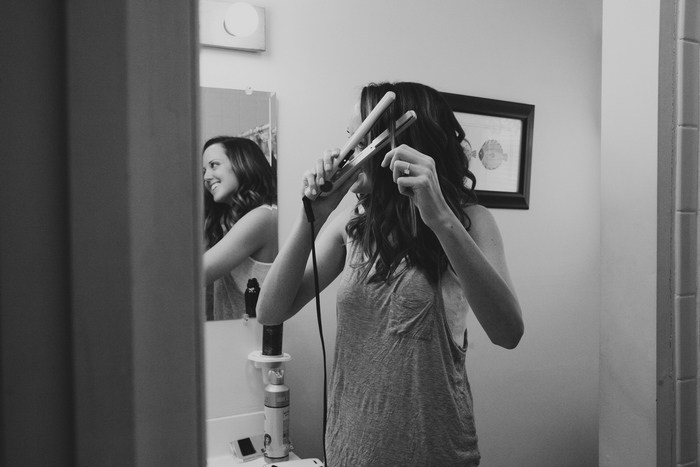 bride flat ironing her hair