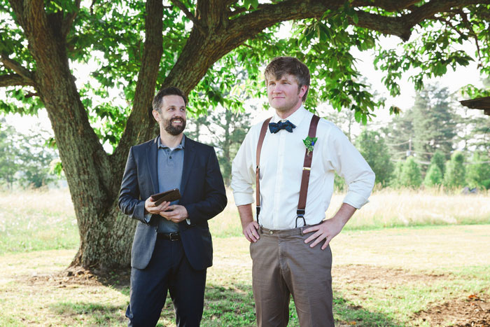 groom waiting at backyard altar