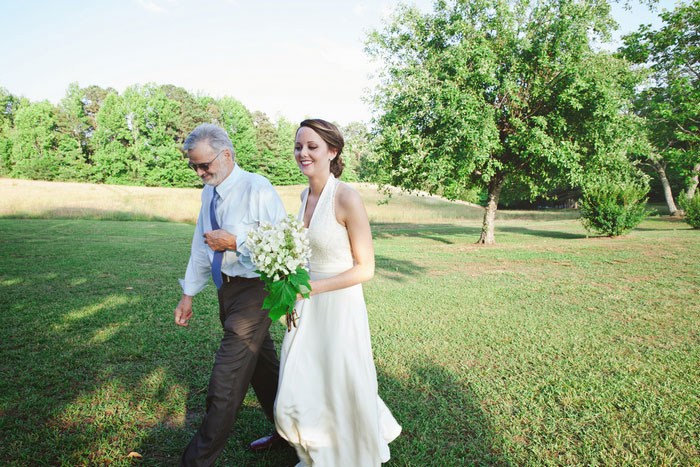 bride walking down aisle with father