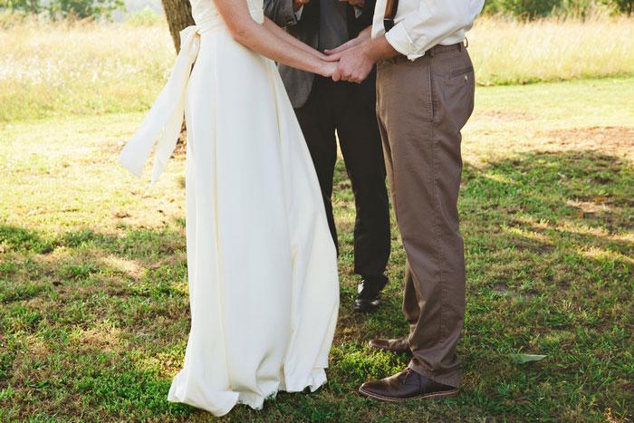 bride and groom holding hands during ceremony 