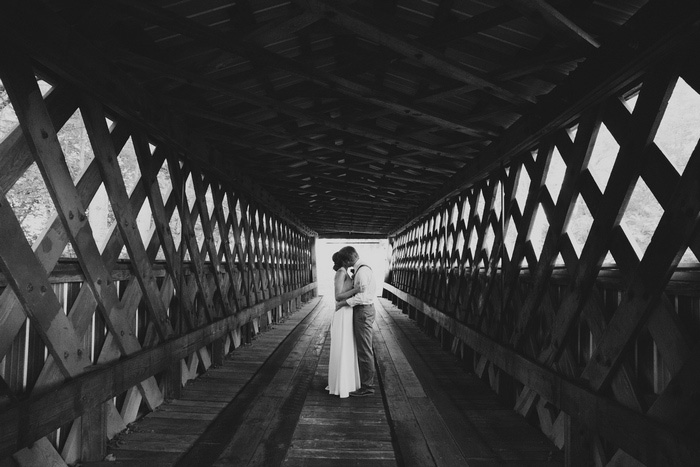 bride and groom portrait on covered bridge