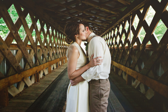 bride and groom portrait on covered bridge