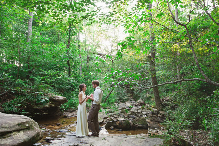 bride and groom portrait in creek