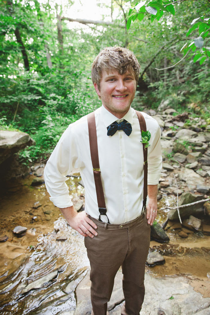 groom portrait in creek