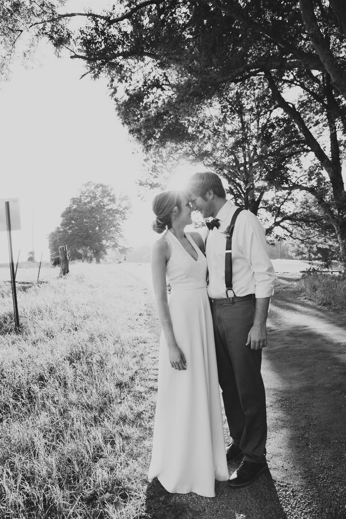 bride and groom portrait on country road