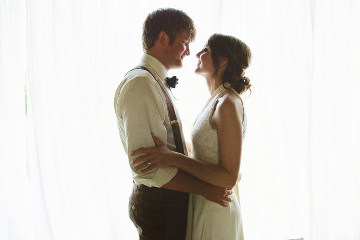 bride and groom portrait against white