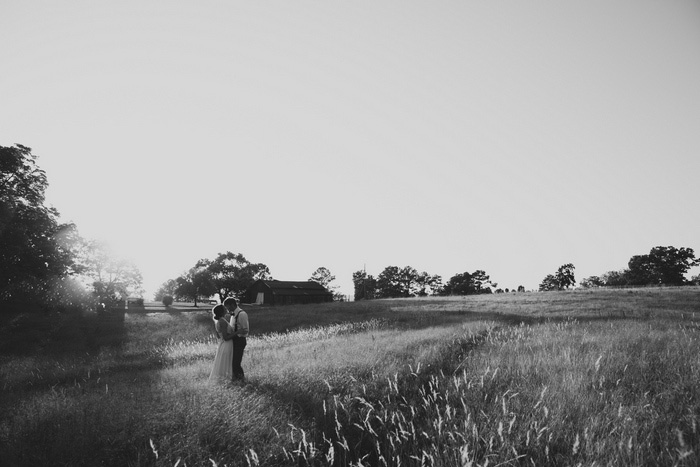 black and white bride and groom portrait in field