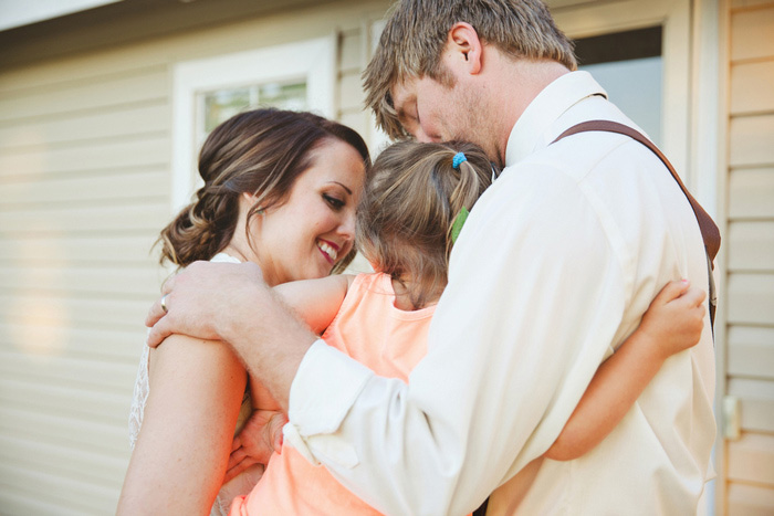 bride and groom with young wedding guest