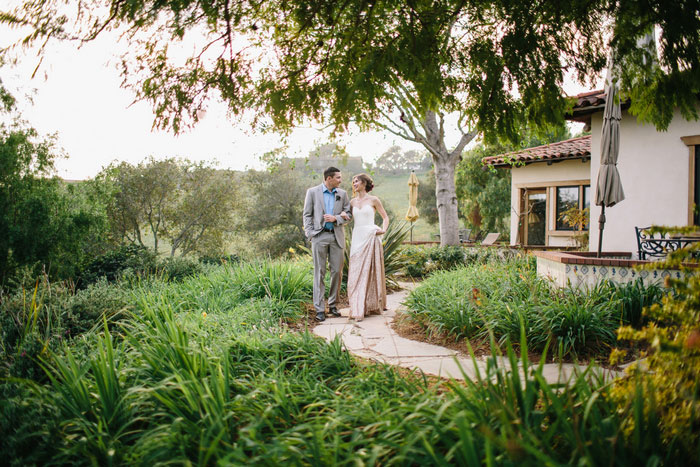 bride and groom walking along estate path