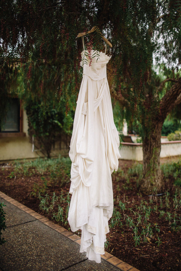 wedding dress hanging in tree