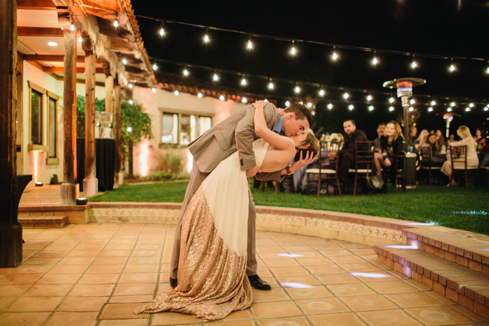 groom dipping and kissing bride on dancefloor