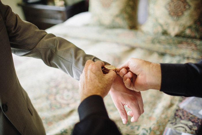 groom having his watch put on