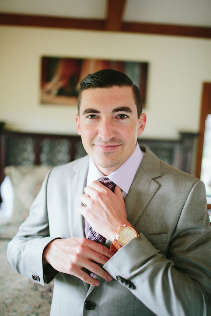 groom adjusting his tie