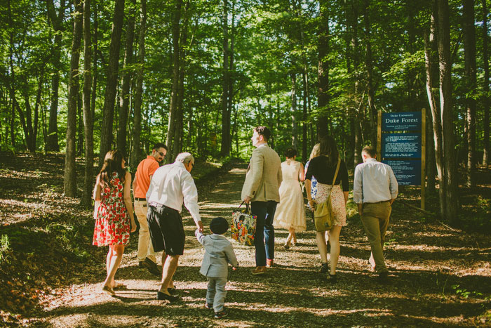 wedding guests walking in the woods