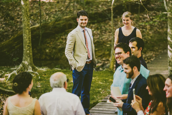 groom waiting at the altar in the woods