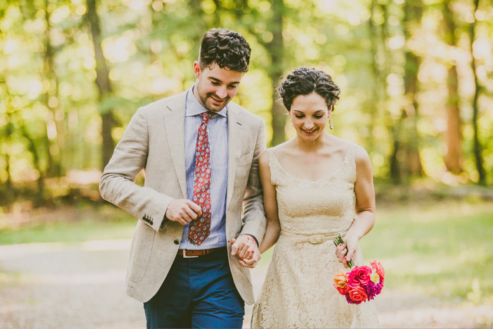 bride and groom walking in the woods