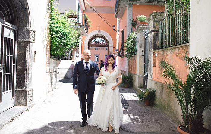 bride walking to the church with her father