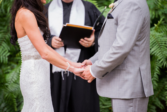 bride and groom holding hands during ceremony