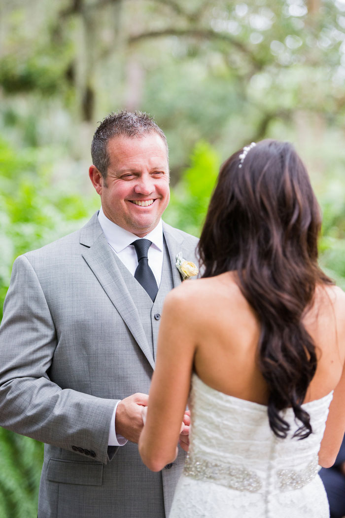 groom smiling at bride during ceremony