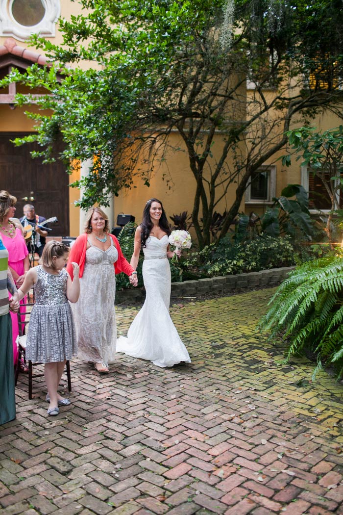 bride walking down the aisle with her mom