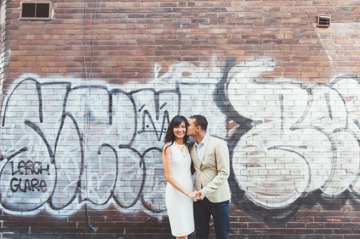 bride and groom portrait in front of graffiti 