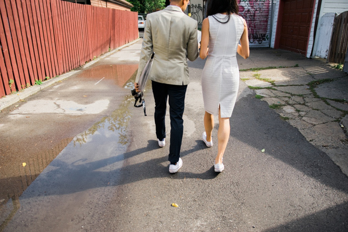 bride and groom walking down laneway