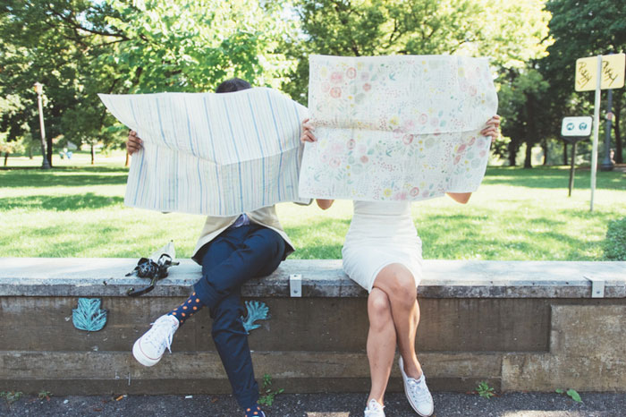 bride and groom reading maps