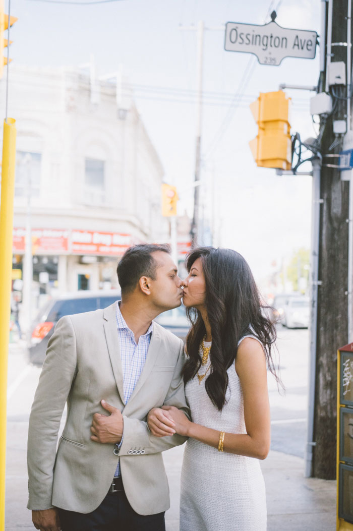 bride and groom kissing on the street