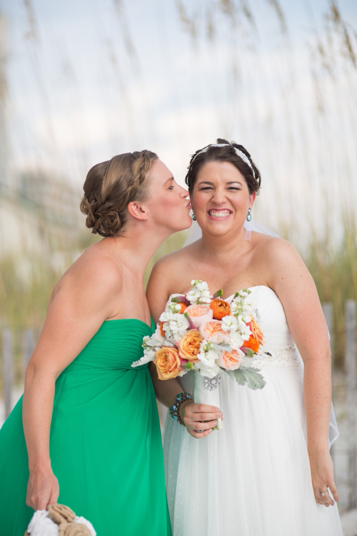 Maid of Honor kissing bride on cheek