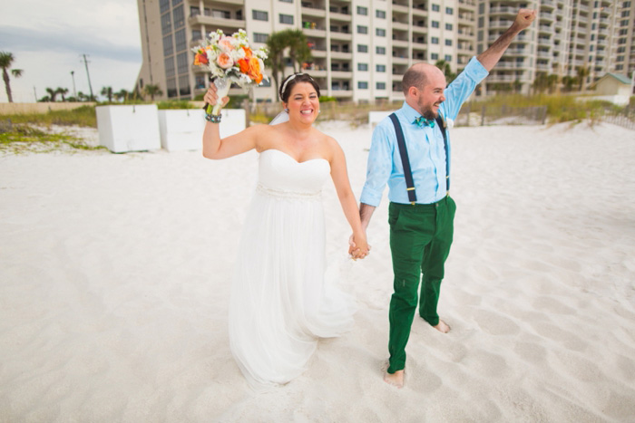 bride and groom celebrating on the beach