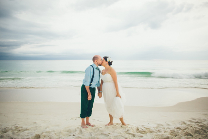 bride and groom kissing on the beach