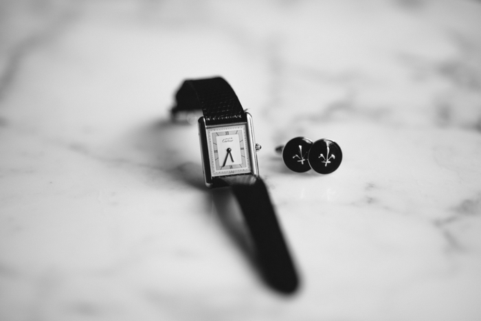 groom's watch and cufflinks laid out