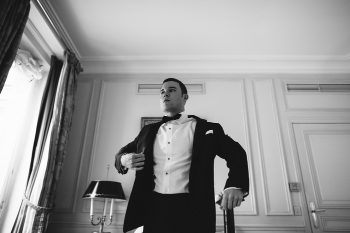 groom putting on his jacket