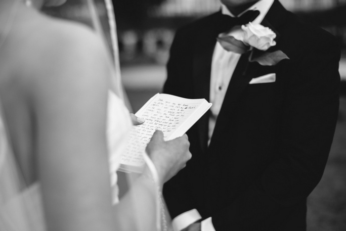 bride holding written vows during ceremony