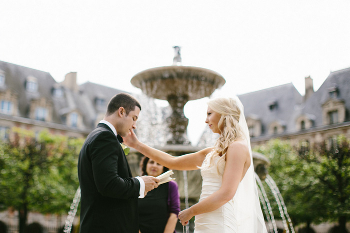 bride wiping away groom's tears during ceremony