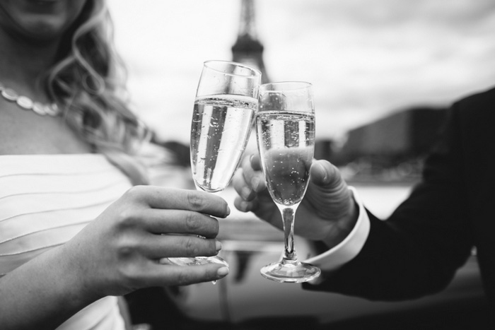 bride and groom clinking glasses