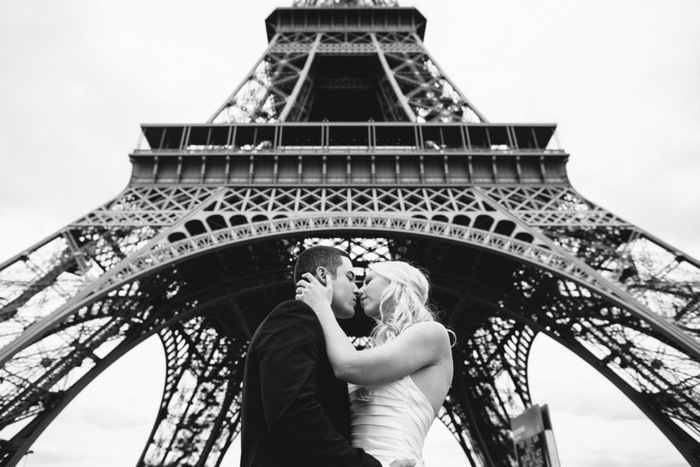 bride and groom under eiffel tower